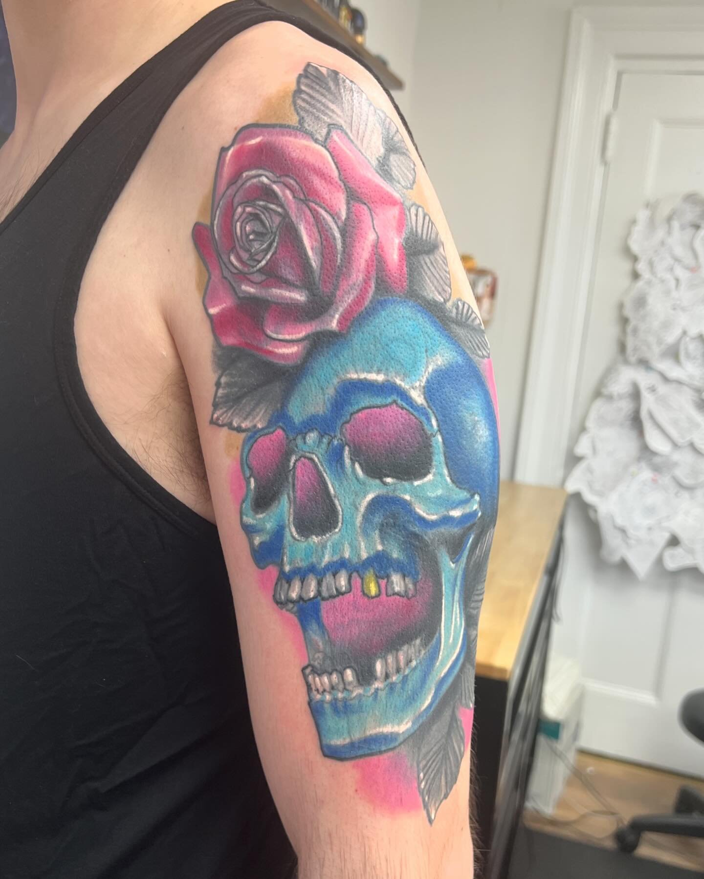 Blue skull with pink rose on watercolor background
