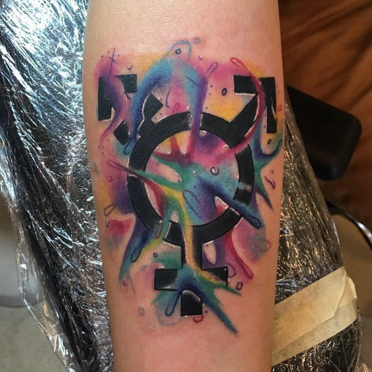 Watercolor transgender symbol with vibrant rainbow color splashes